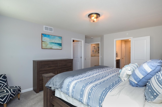 304 Rum River Way, Anoka, MN 55303 - bedroom with light colored carpet, baseboards, and ensuite bath