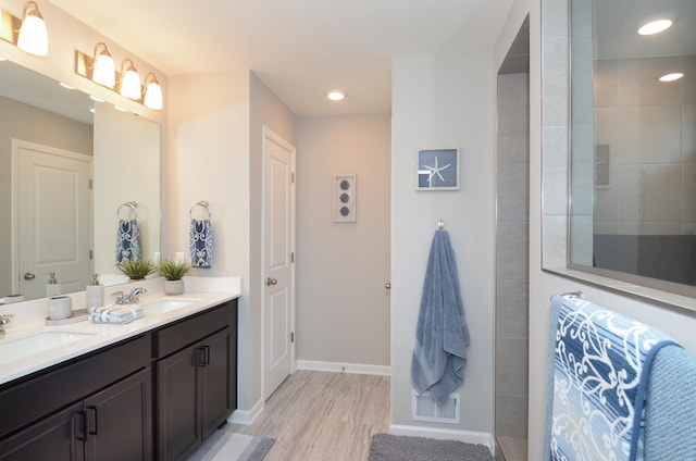 304 Rum River Way, Anoka, MN 55303 - full bath with wood finished floors, walk in shower, double vanity, recessed lighting, and baseboards