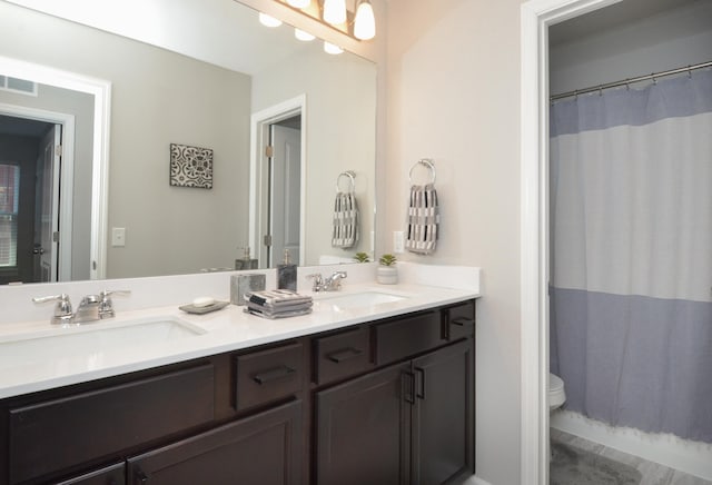 304 Rum River Way, Anoka, MN 55303 - full bath featuring toilet, double vanity, and a shower with curtain