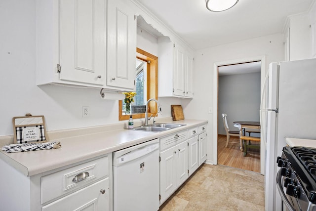 kitchen featuring dishwasher, a sink, stainless steel range with gas cooktop, white cabinetry, and light countertops