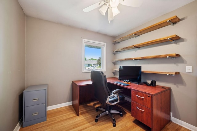 office featuring ceiling fan, light wood-style floors, and baseboards
