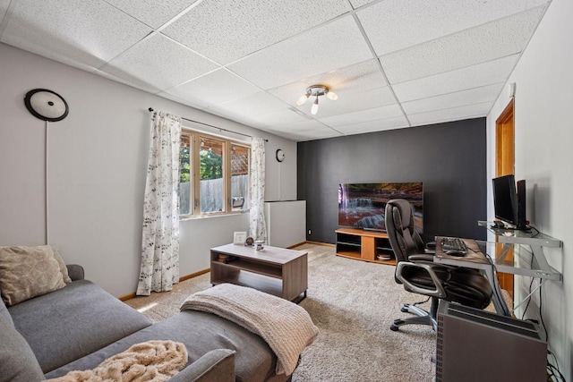 office area with a drop ceiling, carpet flooring, and baseboards