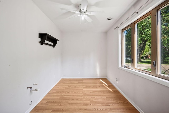 spare room with light wood-style flooring, baseboards, and ceiling fan