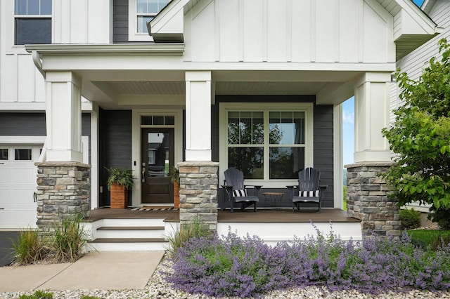 14778 50th St NE, Saint Michael, MN 55376 - property entrance featuring a porch, board and batten siding, stone siding, and a garage