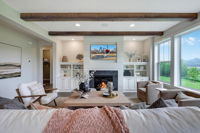 14778 50th St NE, Saint Michael, MN 55376 - living area with wood finished floors, a glass covered fireplace, beam ceiling, and recessed lighting