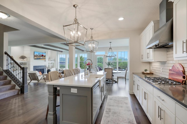 14778 50th St NE, Saint Michael, MN 55376 - kitchen featuring wall chimney exhaust hood, stainless steel appliances, a chandelier, open floor plan, and a breakfast bar