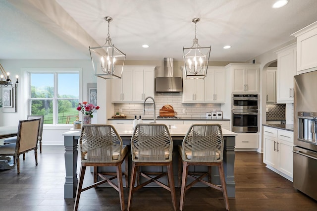14778 50th St NE, Saint Michael, MN 55376 - kitchen with a chandelier, wall chimney range hood, appliances with stainless steel finishes, and recessed lighting