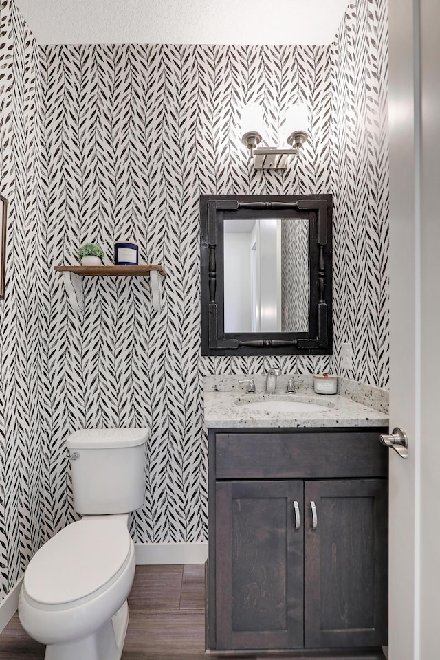 14778 50th St NE, Saint Michael, MN 55376 - bathroom with wallpapered walls, vanity, baseboards, and toilet