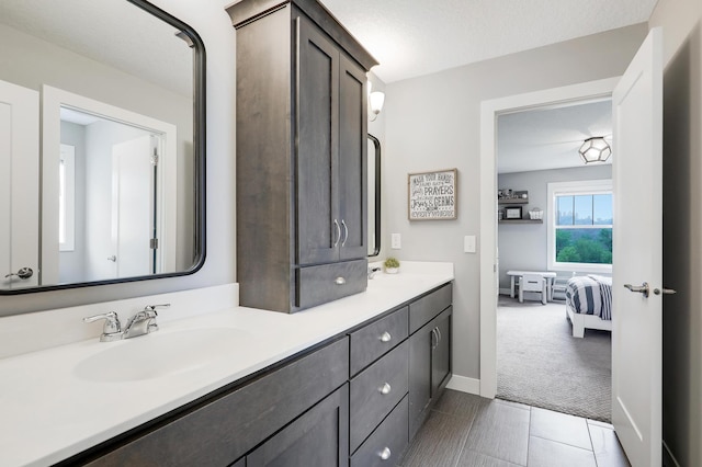 14778 50th St NE, Saint Michael, MN 55376 - ensuite bathroom featuring double vanity, baseboards, and tile patterned flooring