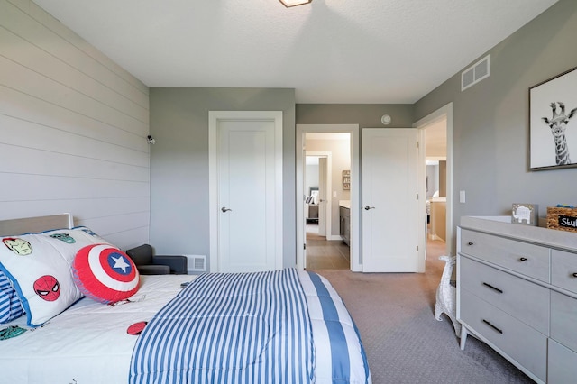 14778 50th St NE, Saint Michael, MN 55376 - carpeted bedroom with wood walls, ensuite bathroom, baseboards, and a textured ceiling