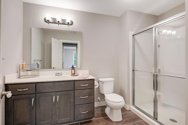 14778 50th St NE, Saint Michael, MN 55376 - bathroom with toilet, vanity, a stall shower, and wood finish floors