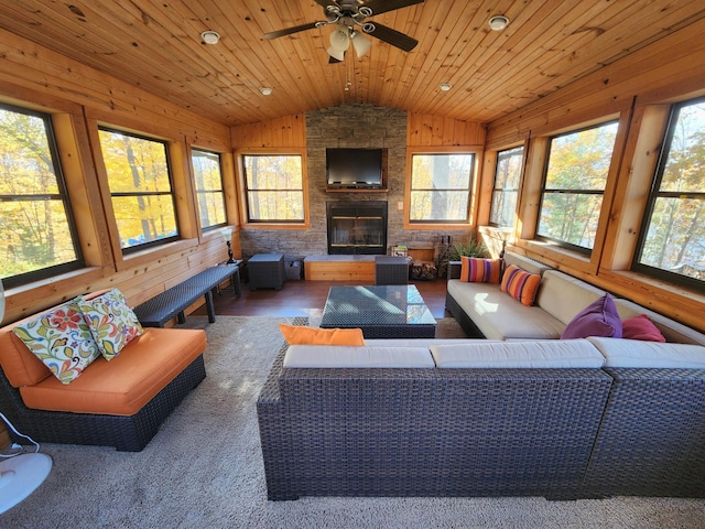 1910 Longwood Point Rd NE, Outing, MN 56662 - living area with vaulted ceiling, healthy amount of natural light, ceiling fan, wooden walls, and wooden ceiling