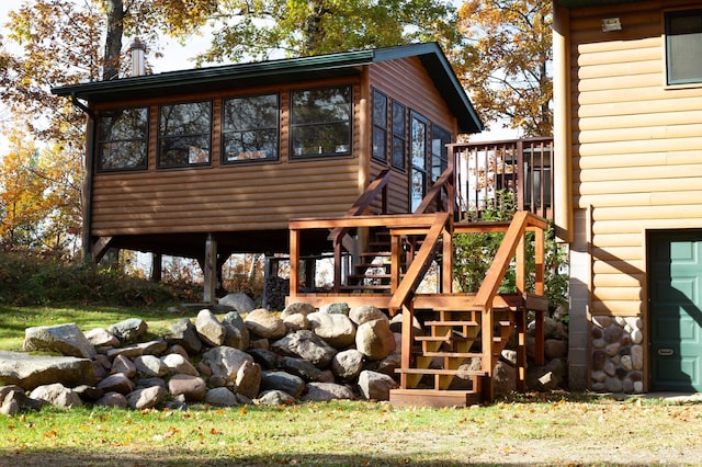 1910 Longwood Point Rd NE, Outing, MN 56662 - view of side of property with stairs, faux log siding, and a wooden deck