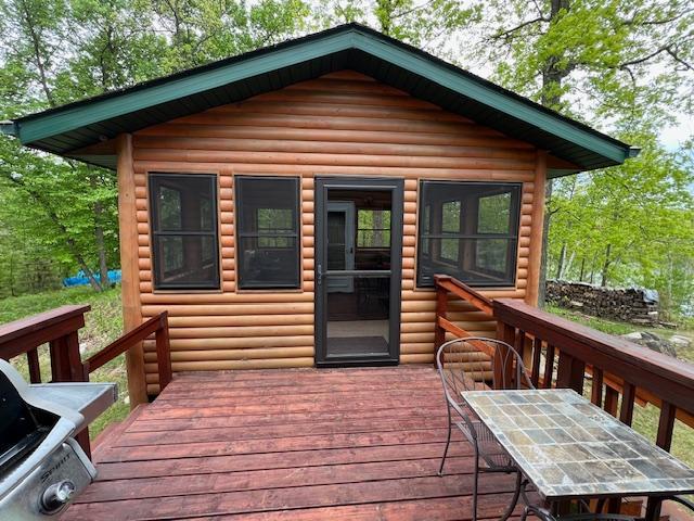 1910 Longwood Point Rd NE, Outing, MN 56662 - wooden deck with a grill and outdoor dining space