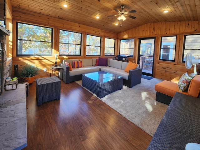 1910 Longwood Point Rd NE, Outing, MN 56662 - living area with lofted ceiling, wood finished floors, wood walls, wood ceiling, and a ceiling fan