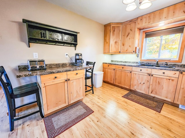 1910 Longwood Point Rd NE, Outing, MN 56662 - kitchen featuring light brown cabinets, a sink, and light wood-style flooring