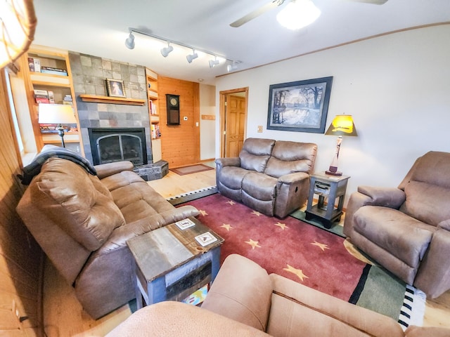 1910 Longwood Point Rd NE, Outing, MN 56662 - living room with a fireplace, a ceiling fan, rail lighting, and wood finished floors