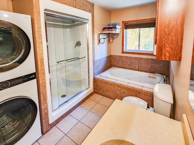 1910 Longwood Point Rd NE, Outing, MN 56662 - full bath featuring stacked washer / dryer, a shower stall, tile patterned flooring, a garden tub, and vanity