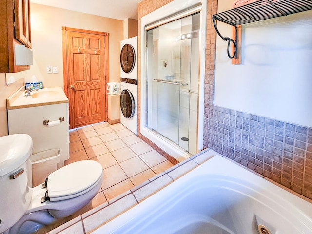 1910 Longwood Point Rd NE, Outing, MN 56662 - bathroom with stacked washing machine and dryer, toilet, a stall shower, tile patterned floors, and a tub with jets