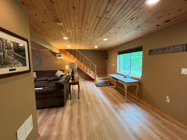 1910 Longwood Point Rd NE, Outing, MN 56662 - living area with wooden ceiling, stairway, wood finished floors, recessed lighting, and baseboards
