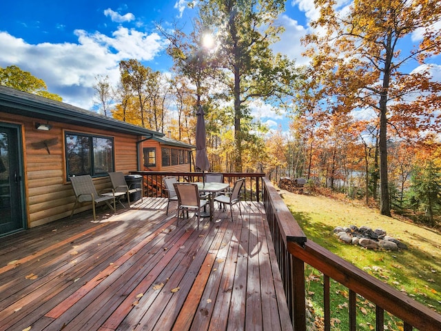 1910 Longwood Point Rd NE, Outing, MN 56662 - deck featuring outdoor dining area, a fire pit, and a lawn