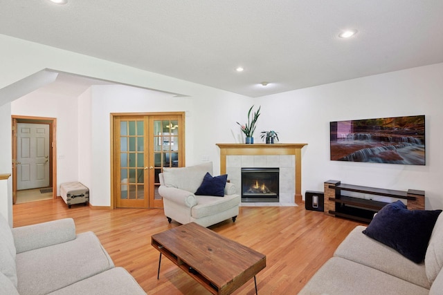 1780 Quail Dr, Shakopee, MN 55379 - living area featuring light wood-style flooring, a tile fireplace, recessed lighting, and french doors