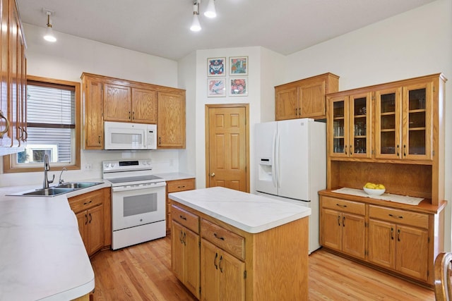 1780 Quail Dr, Shakopee, MN 55379 - kitchen with white appliances, a sink, light wood-style flooring, and a center island