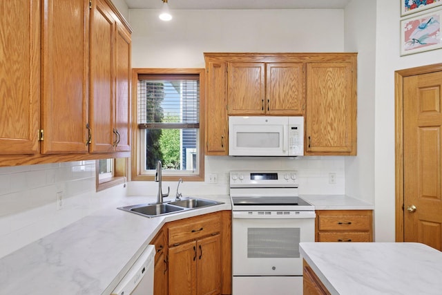 1780 Quail Dr, Shakopee, MN 55379 - kitchen with white appliances, a sink, decorative backsplash, and light countertops