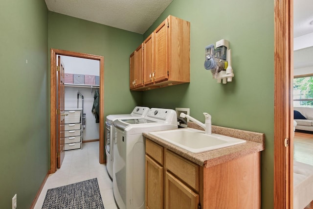 1780 Quail Dr, Shakopee, MN 55379 - laundry room featuring cabinet space, independent washer and dryer, a textured ceiling, light tile patterned floors, and baseboards