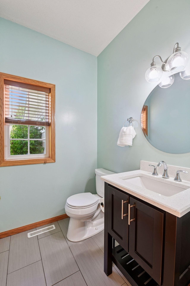 1780 Quail Dr, Shakopee, MN 55379 - bathroom featuring vanity, toilet, and baseboards