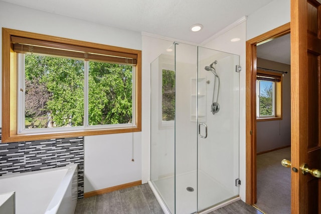 1780 Quail Dr, Shakopee, MN 55379 - bathroom with a stall shower, a bath, baseboards, backsplash, and recessed lighting