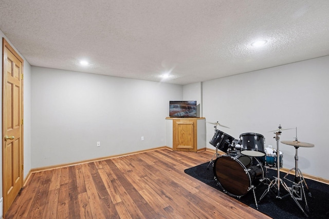1780 Quail Dr, Shakopee, MN 55379 - rec room featuring a textured ceiling, wood finished floors, baseboards, and recessed lighting