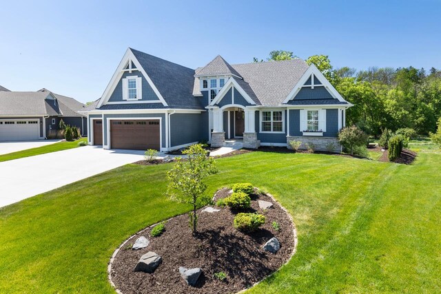 5980 Prestwick Ct, Shorewood, MN 55331 - view of front facade with concrete driveway, a front lawn, a garage, and a shingled roof
