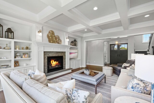 5980 Prestwick Ct, Shorewood, MN 55331 - living room with a stone fireplace, beam ceiling, built in shelves, coffered ceiling, and light wood-style floors