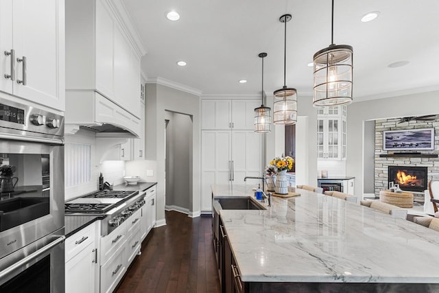 5980 Prestwick Ct, Shorewood, MN 55331 - kitchen with stainless steel appliances, a sink, a spacious island, recessed lighting, and dark wood-style floors