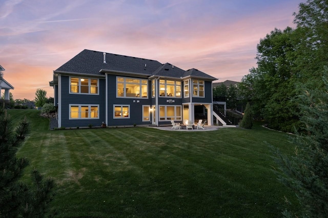 5980 Prestwick Ct, Shorewood, MN 55331 - back of property at dusk featuring a patio area, stairway, and a lawn