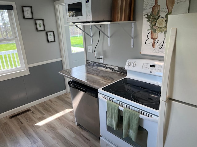 603 Main Ave N, Roseau, MN 56751 - kitchen with white appliances and light wood-type flooring
