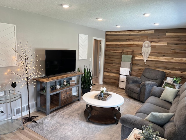 603 Main Ave N, Roseau, MN 56751 - living area with wood finished floors, wooden walls, baseboards, an accent wall, and a textured ceiling