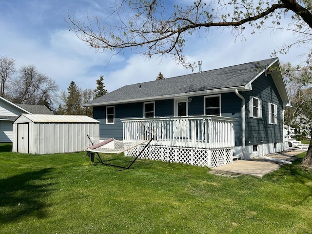 603 Main Ave N, Roseau, MN 56751 - back of property with a yard, an outbuilding, a shed, and a shingled roof