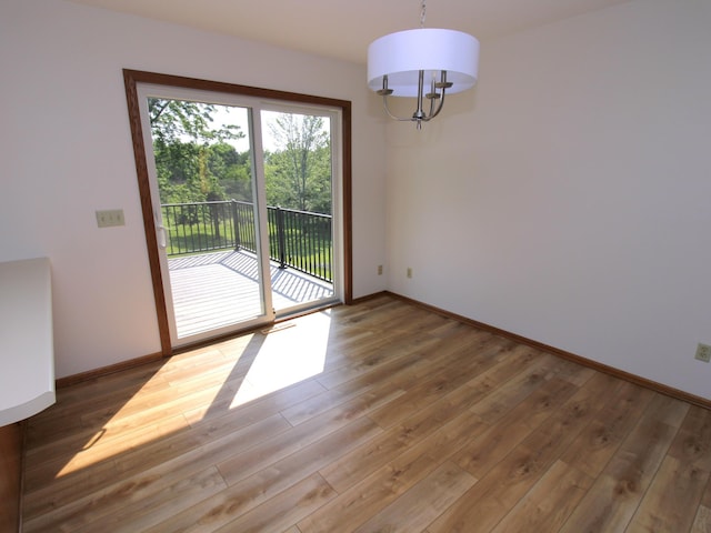 538 Nordic Ln, Troy Twp, WI 54016 - unfurnished dining area featuring wood finished floors, baseboards, and a chandelier