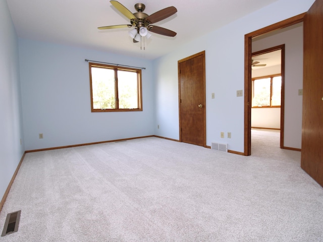538 Nordic Ln, Troy Twp, WI 54016 - unfurnished bedroom with light colored carpet, baseboards, and ceiling fan