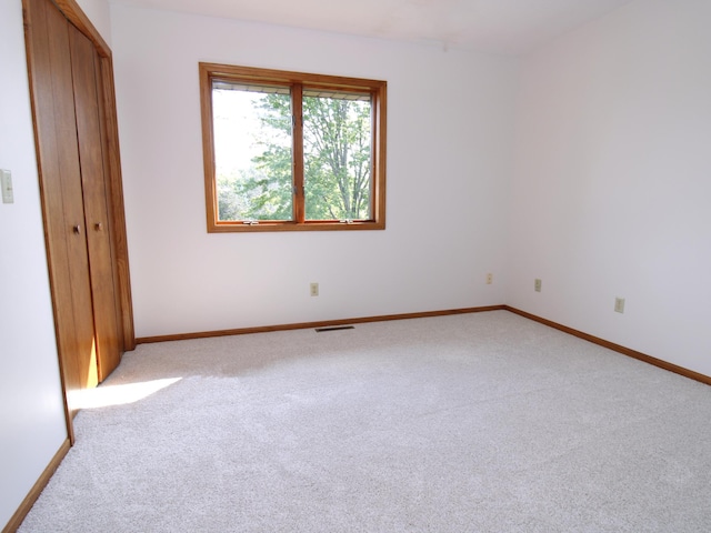 538 Nordic Ln, Troy Twp, WI 54016 - unfurnished bedroom with light colored carpet, baseboards, and a closet