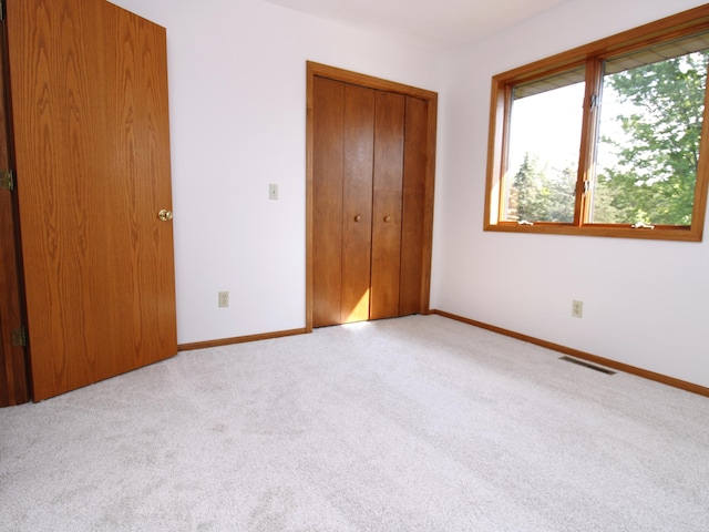 538 Nordic Ln, Troy Twp, WI 54016 - unfurnished bedroom featuring carpet, a closet, and baseboards