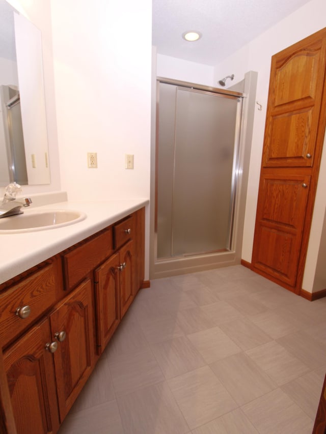 538 Nordic Ln, Troy Twp, WI 54016 - bathroom featuring vanity, a shower stall, baseboards, and tile patterned floors