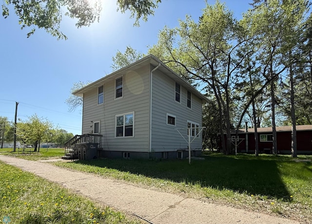view of side of home with a yard