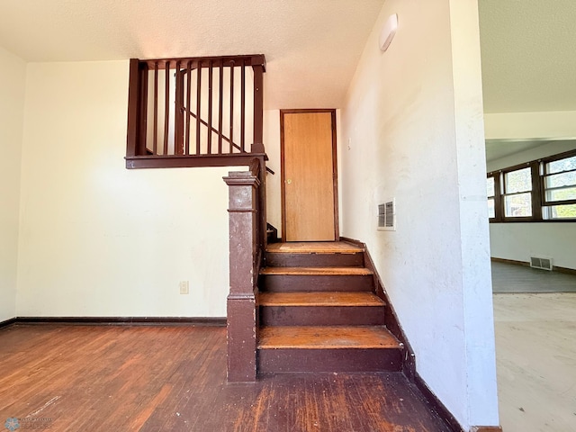 stairs with baseboards and wood finished floors