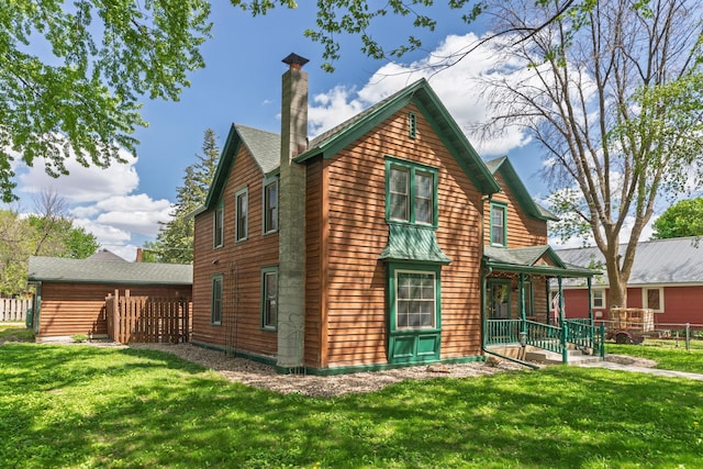 210 1st St SE, Hayfield, MN 55940 - view of home's exterior featuring a porch and a chimney