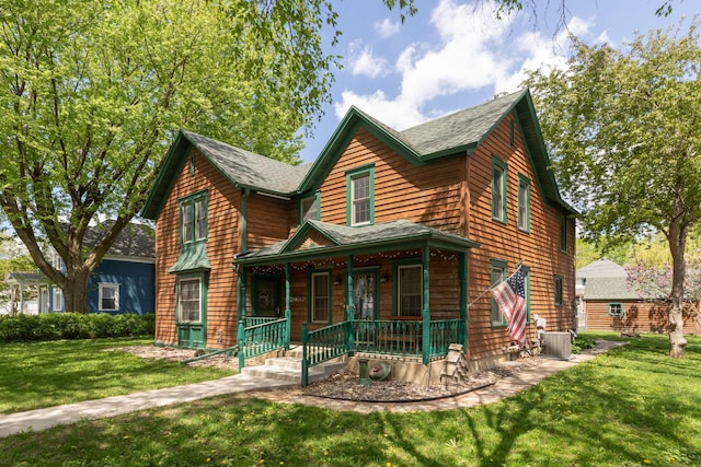 210 1st St SE, Hayfield, MN 55940 - view of front of property with covered porch, central AC, a front lawn, and roof with shingles