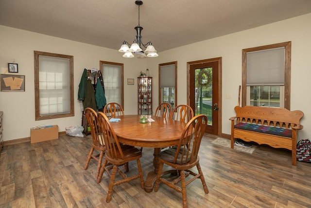 210 1st St SE, Hayfield, MN 55940 - dining area with a chandelier, wood finished floors, and baseboards