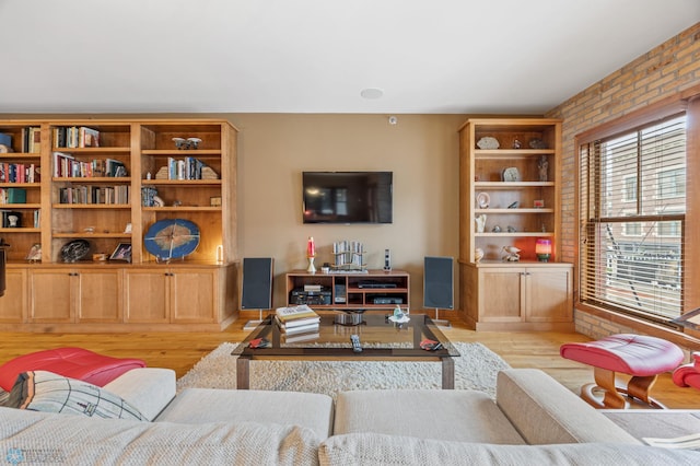 300 Broadway N Unit 204, Fargo, ND 58102 - living room with brick wall, wood finished floors, and baseboards